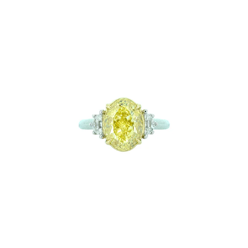 18 Karat White and Yellow Gold Three Stone Ring with Oval Cut Fancy Yellow Diamond and white Half moon diamonds